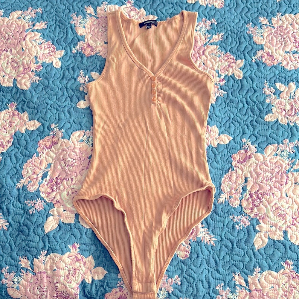 This is an Ambiance light pink tank top body suit.